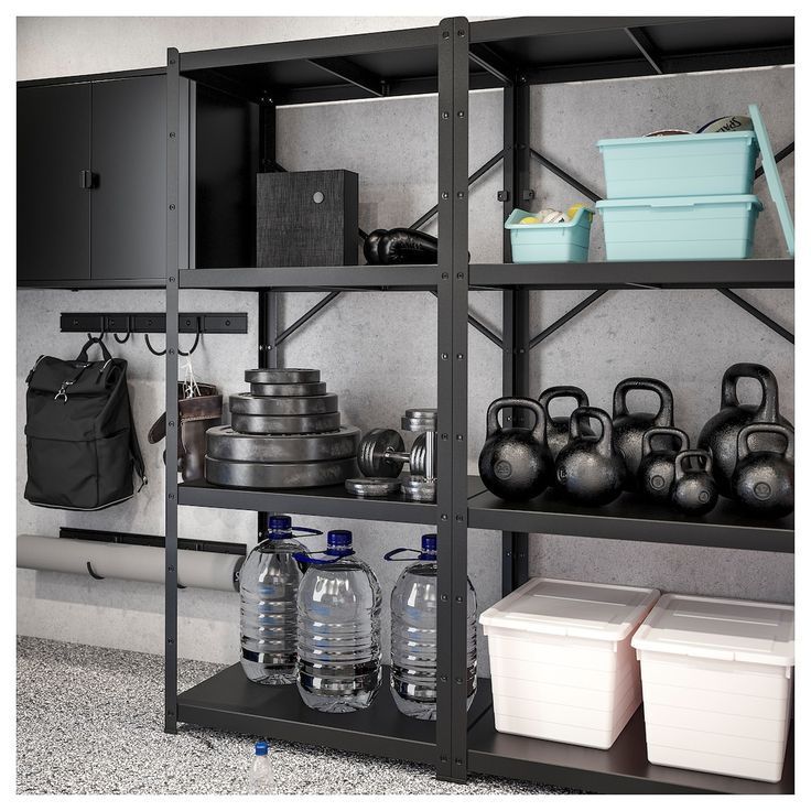 the shelves are filled with different types of sports equipment and storage bins on them