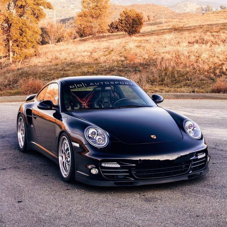 a black sports car parked in a parking lot