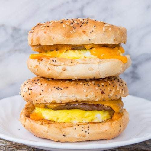 three bagels stacked on top of each other with eggs and cheese in between them