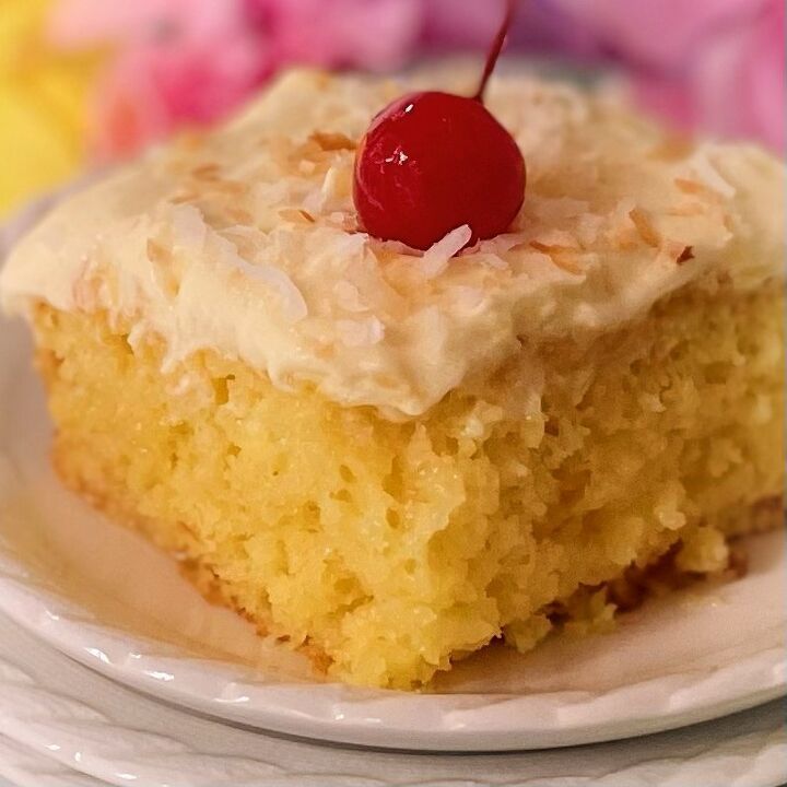 a close up of a piece of cake on a plate with a cherry on top