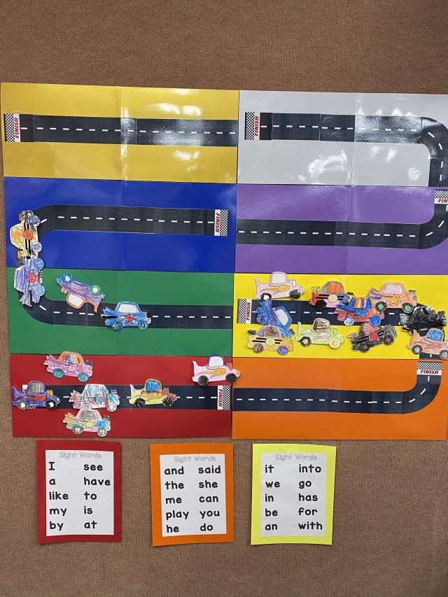 a bulletin board with cars on the road and i see, who is driving?