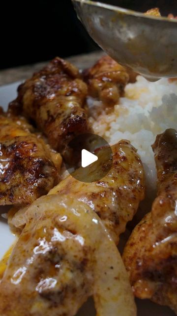 chicken wings covered in sauce and rice on a plate