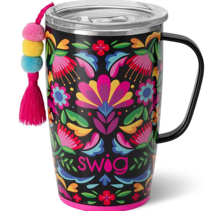 a colorful mug with a tasseled handle and lid is shown in front of a white background