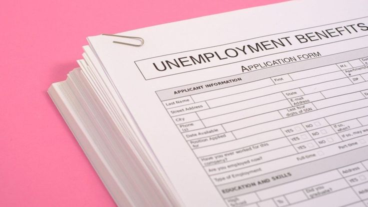 a pile of employment forms sitting on top of a pink table