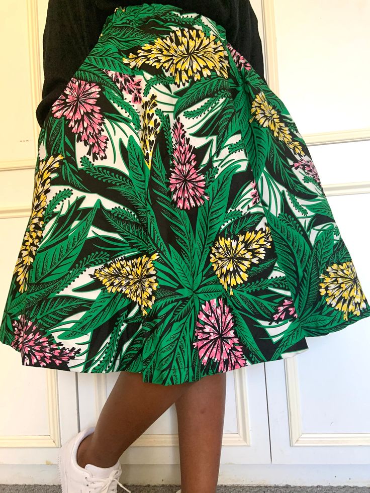 Ankara full circle skirt brightly coloured with elastic waist band and side pockets. The elastic band in its relaxed measurement is true to size ,its stretched measurement can fit the next size up.  This skirt can be worn and styled multi ways can be dressed down casually or dressed up for a glam look. Green Skirt With Elastic Stretch Waistband, Green Cotton Mini Skirt With Elastic Waistband, Green Tiered Skirt With Pockets, Green Floral Print Relaxed Skirt, Green Flared Skirt With Elastic Waistband, Green Flared Skirt With Floral Print, Printed Relaxed Midi Skirt, Green Floral Print Midi Skirt, A-line Floral Print Relaxed Skirt