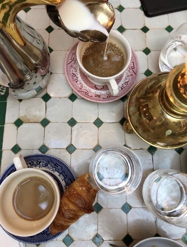 two cups of coffee are being poured into the mugs on top of each other