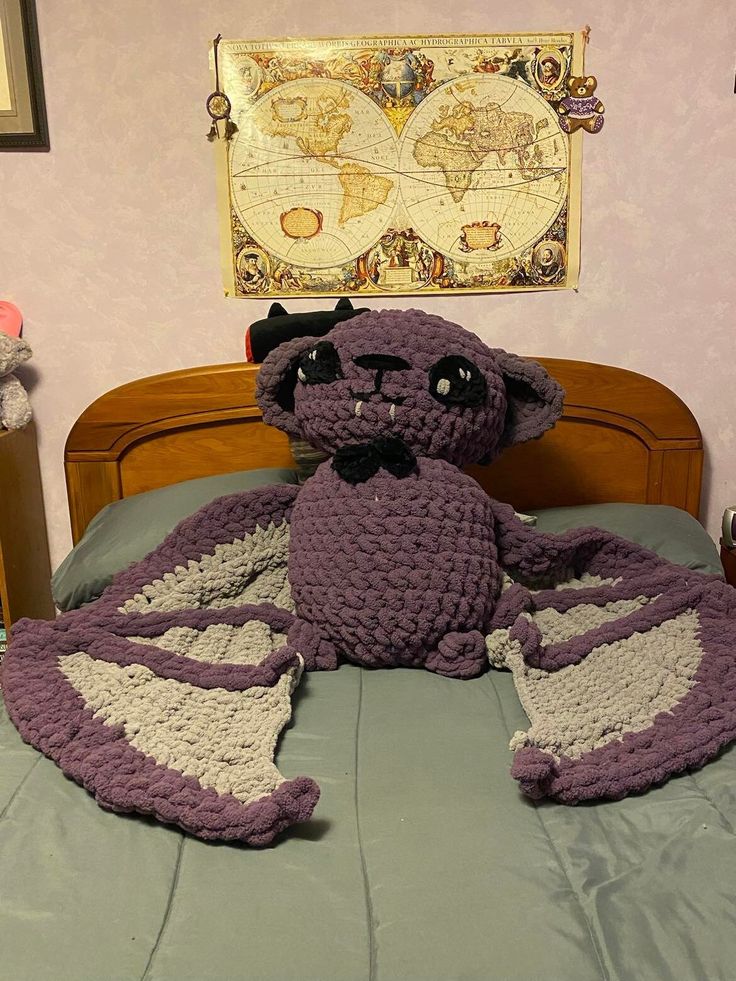 a crocheted stuffed animal laying on top of a bed