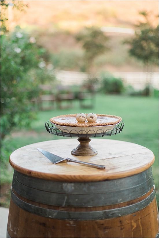 a cake plate sitting on top of a wooden barrel