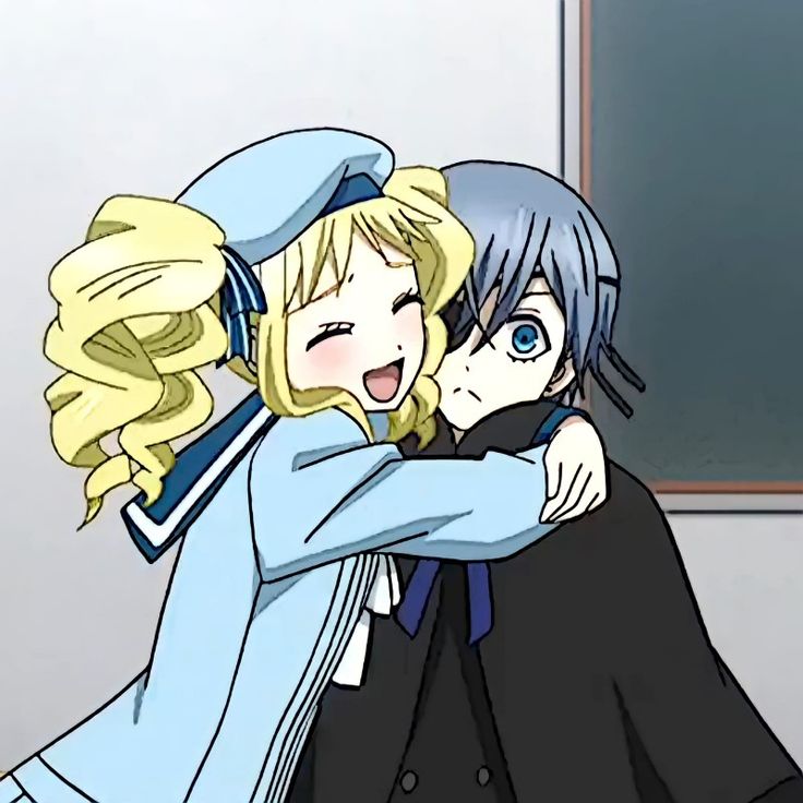 two anime characters hugging each other in front of a blackboard