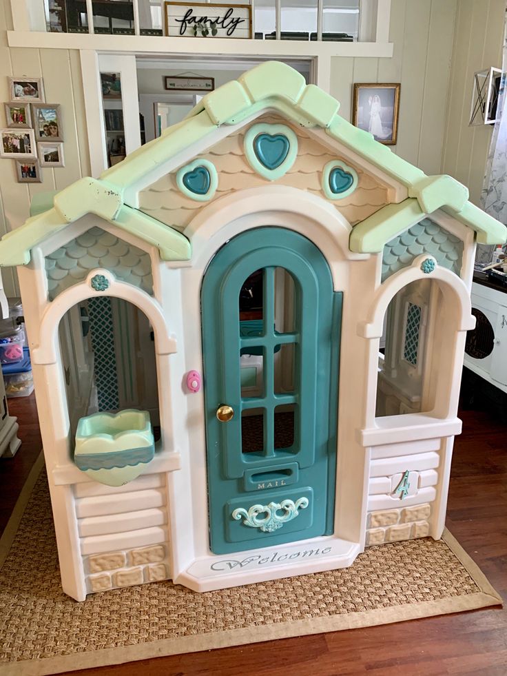 a play house with blue doors and windows