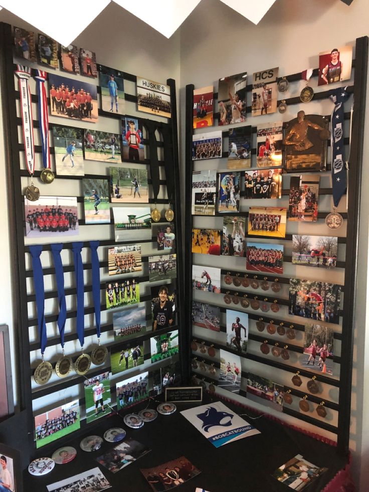 two display cases filled with sports memorabilia on top of a black table next to each other