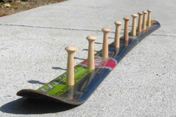 a skateboard with wooden posts on the side of it and some poles sticking out