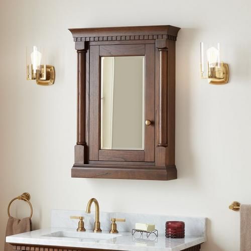 a bathroom with a sink, mirror and lights on the wall next to toilet paper