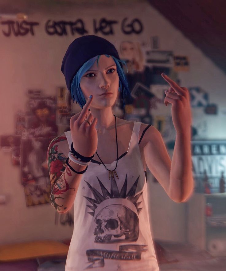 a woman with blue hair and tattoos making the peace sign in front of her face