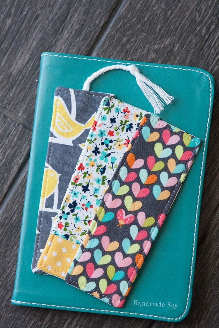 a wallet with some fabric on it sitting on top of a wooden table next to a piece of cloth