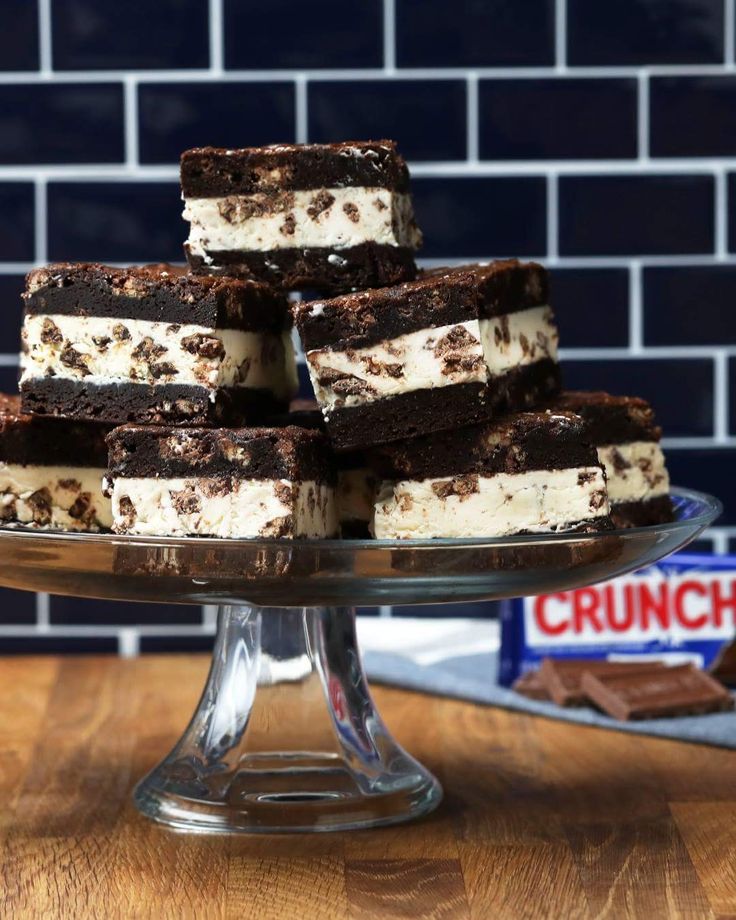 several pieces of cake sitting on top of a glass plate next to a bag of cookies