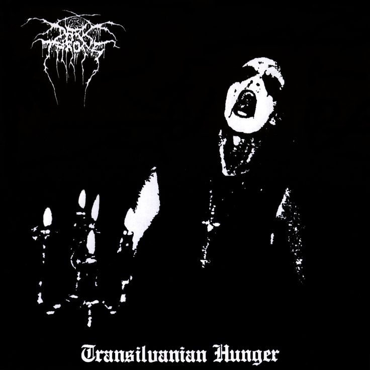 a black and white image of a demon with his mouth open in front of him