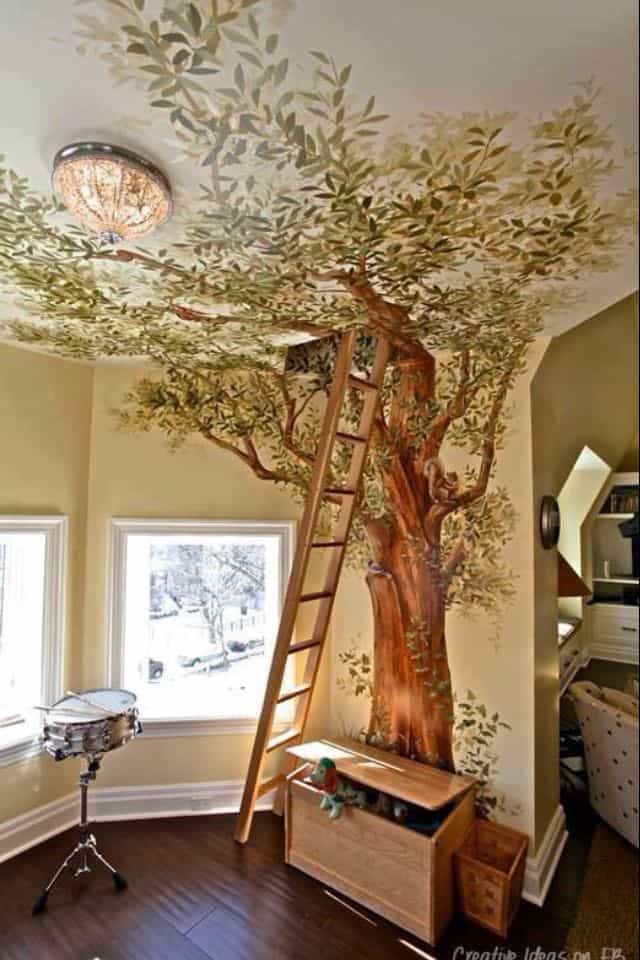 a room with a tree painted on the ceiling and ladder up to it's top