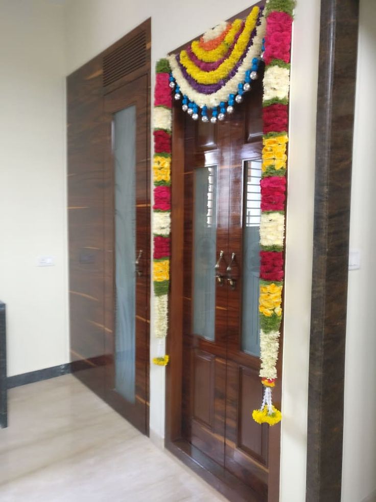 an entrance decorated with flowers and garlands