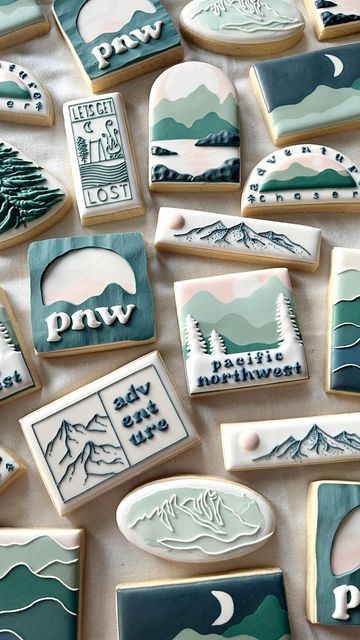 decorated cookies with mountains and trees on them