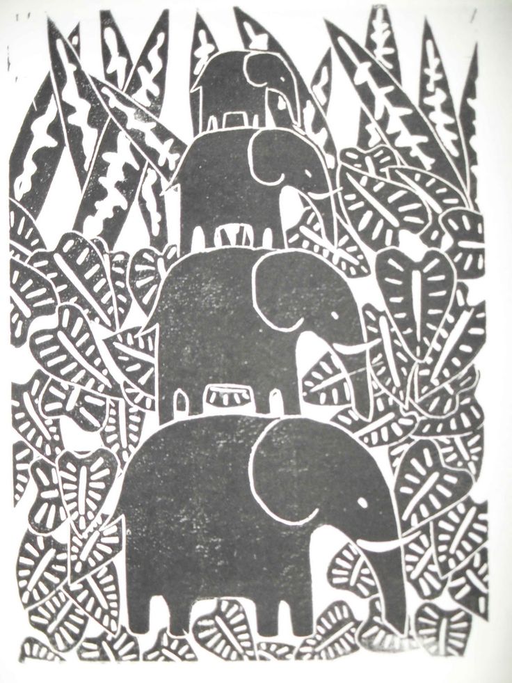 two elephants are standing in the middle of some plants and trees, one is black and white