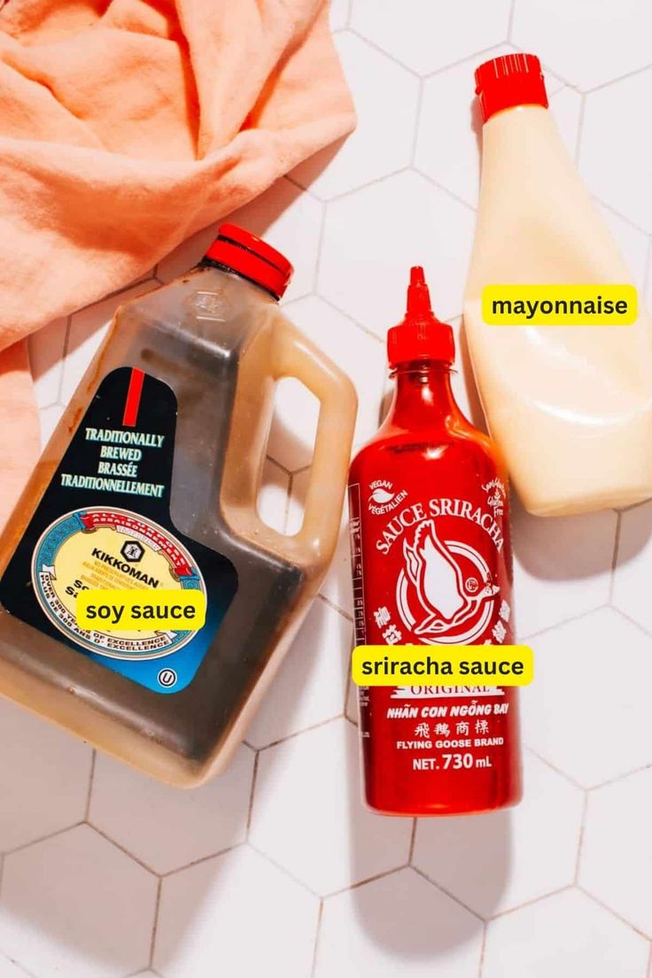 the ingredients to make homemade mayonnaise are displayed on a tile floor next to an orange towel