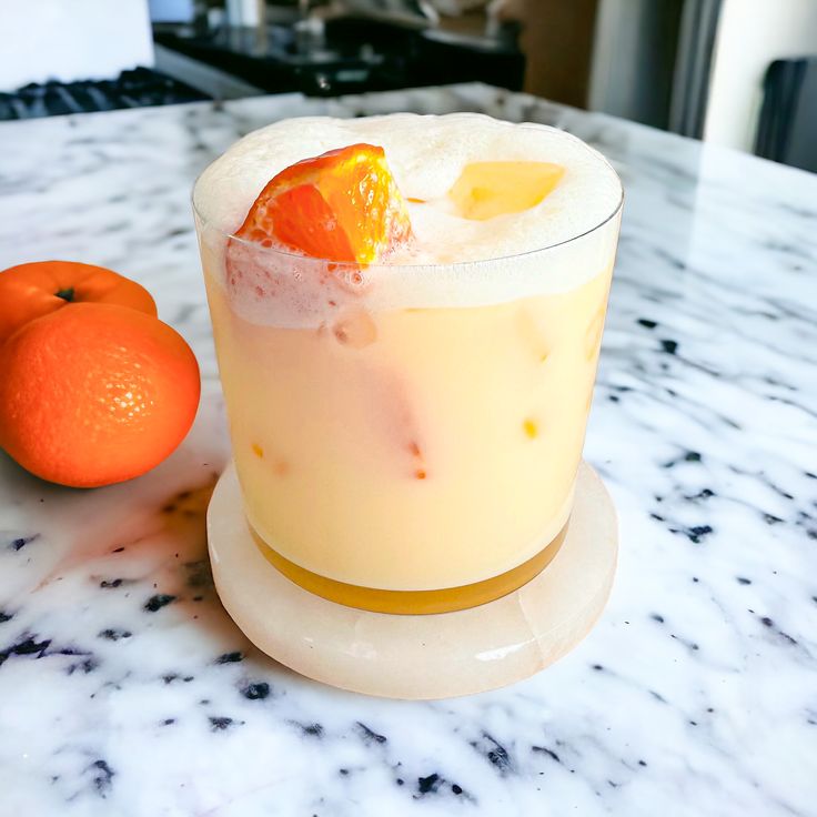 an orange sitting on top of a counter next to a drink