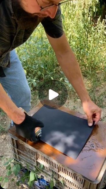 a man is working on an outdoor heater in the woods with his hands and fingers