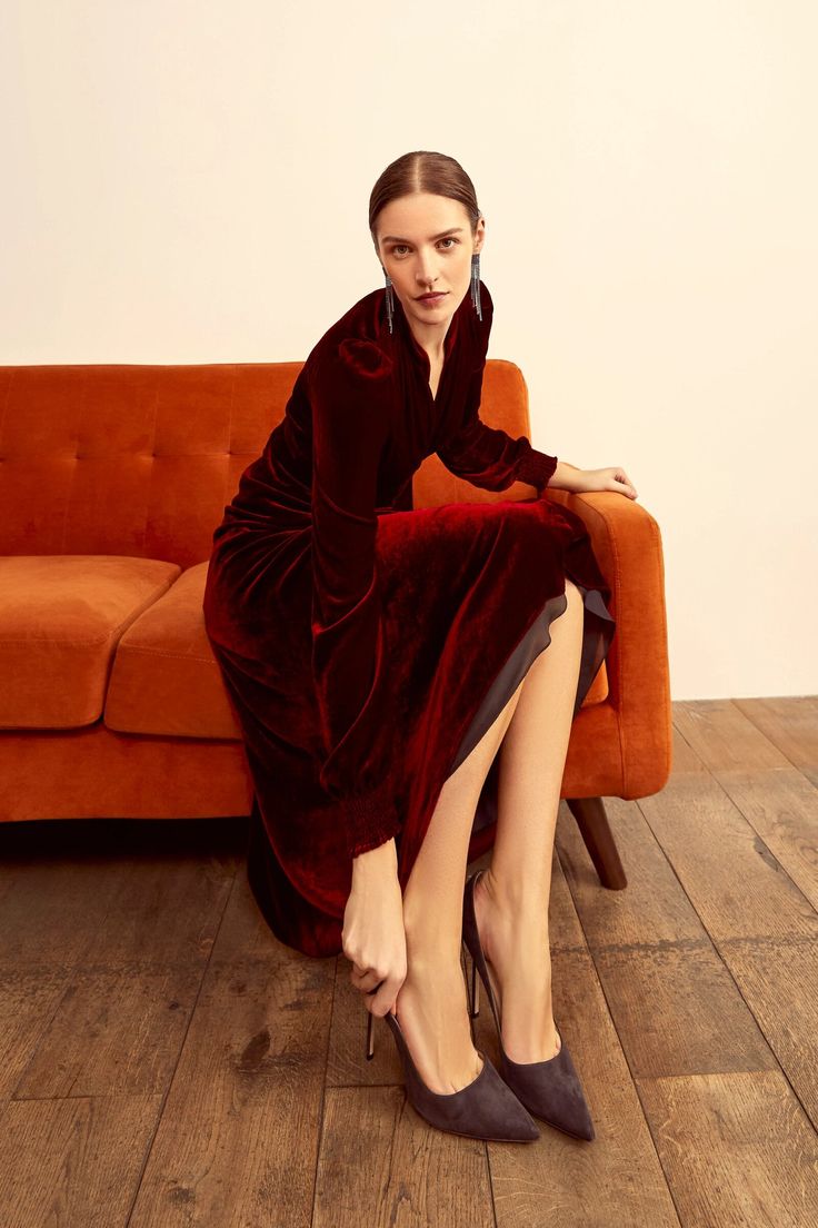 A truly elegant midi length velvet dress, based on our signature 1930s tea dress block. Cut from soft, fluid Italian velvet in a rich ruby red, the dress has full length sleeves with a shirred cuff, a shirred elasticated empire seam and bias cut silhouette, falling to a midi length. The neckline has a small stand collar that frames the face beautifully, and there is an invisible centre back zip for step-in ease. The dress is lined from the empire seam to the hemline in Italian silk habotai. Step Suzannah London, Gown Suit, Luxury Clutch, Boutique Couture, Winter Event, Wrap Jacket, Uk Size 16, Block Dress, Evening Dresses Elegant