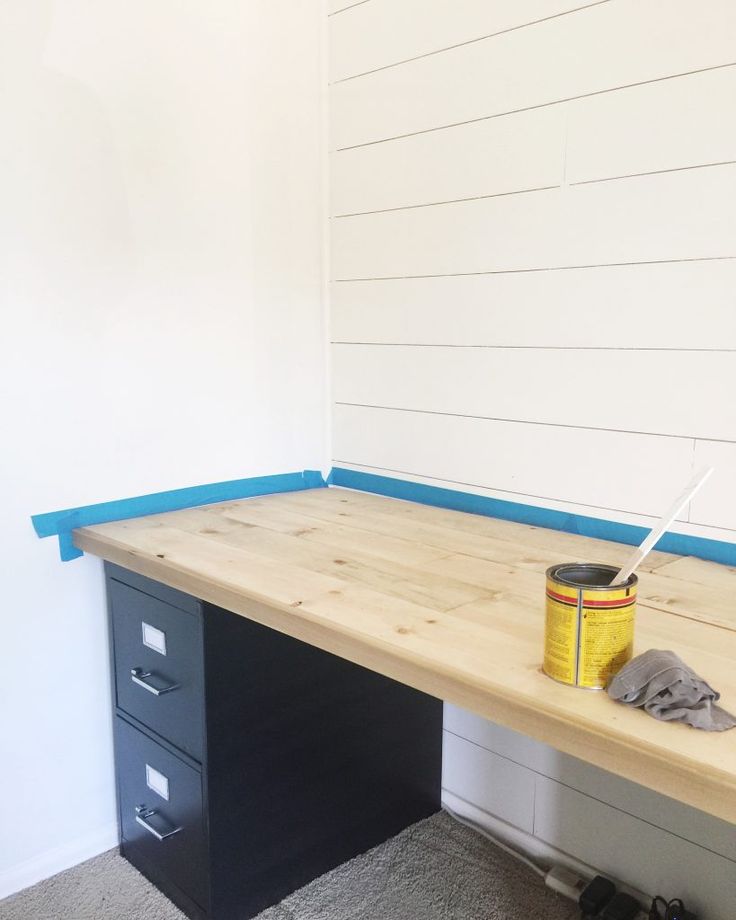 an empty desk with a can of paint on it