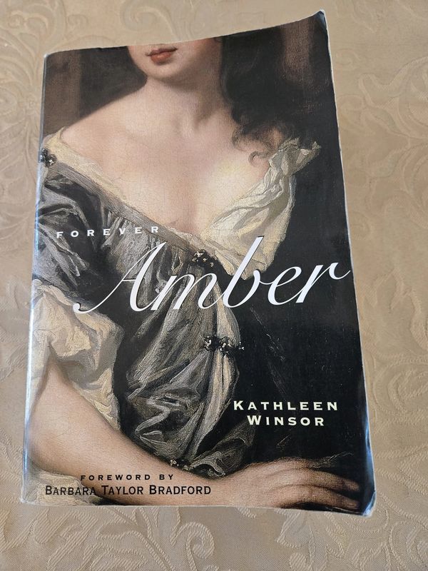 a book with an image of a woman's face on it, and the words amber written in cursive writing