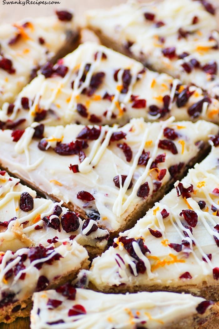 white chocolate and cranberry shortbread with orange zest on a cutting board