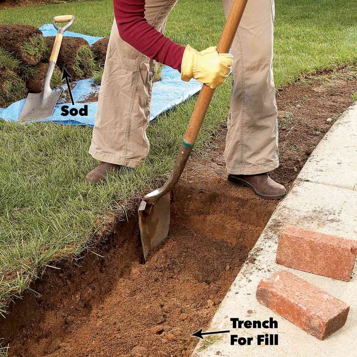 a man is digging in the ground with a shovel and some bricks to put together