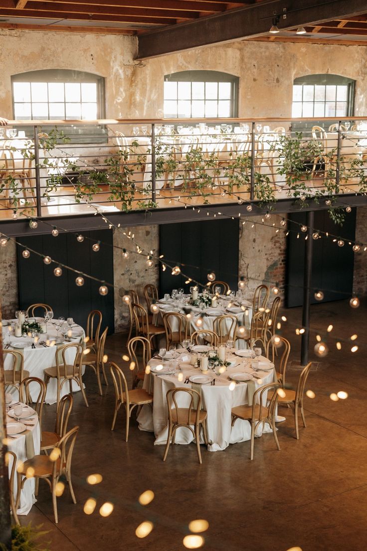 an indoor wedding venue with tables and chairs