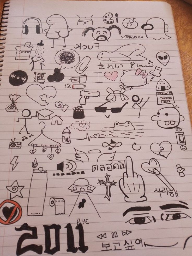 an open notebook with doodles on it and various symbols in the pages, all drawn by hand