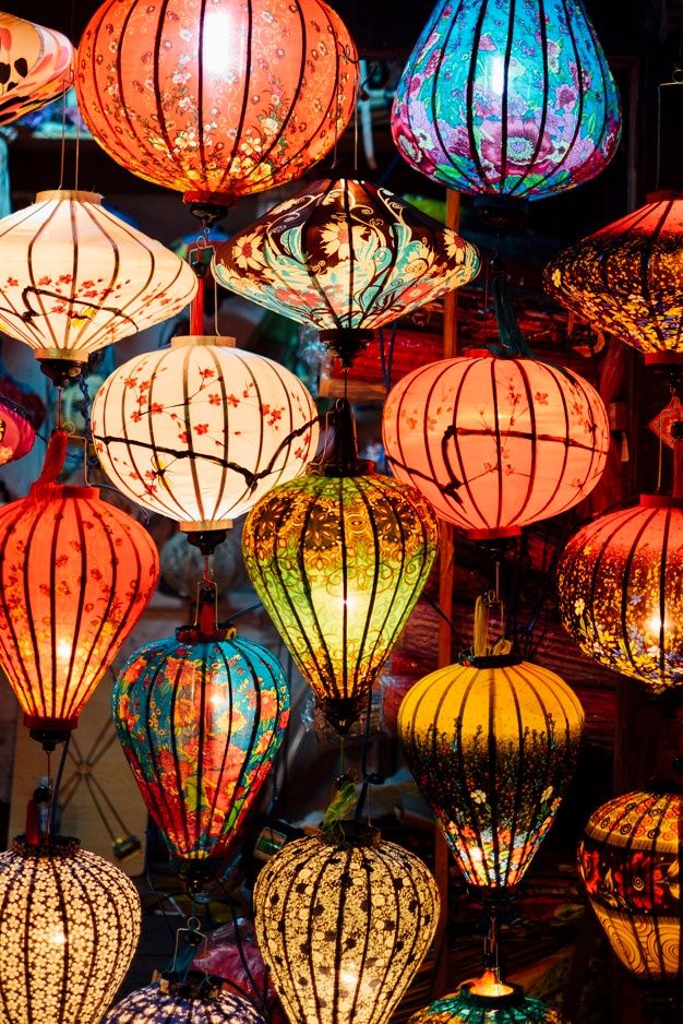 many colorful lanterns are lit up in the dark