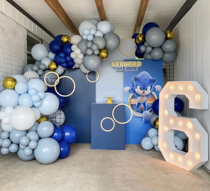 a room filled with balloons and lights in the shape of sonic's birthday decorations