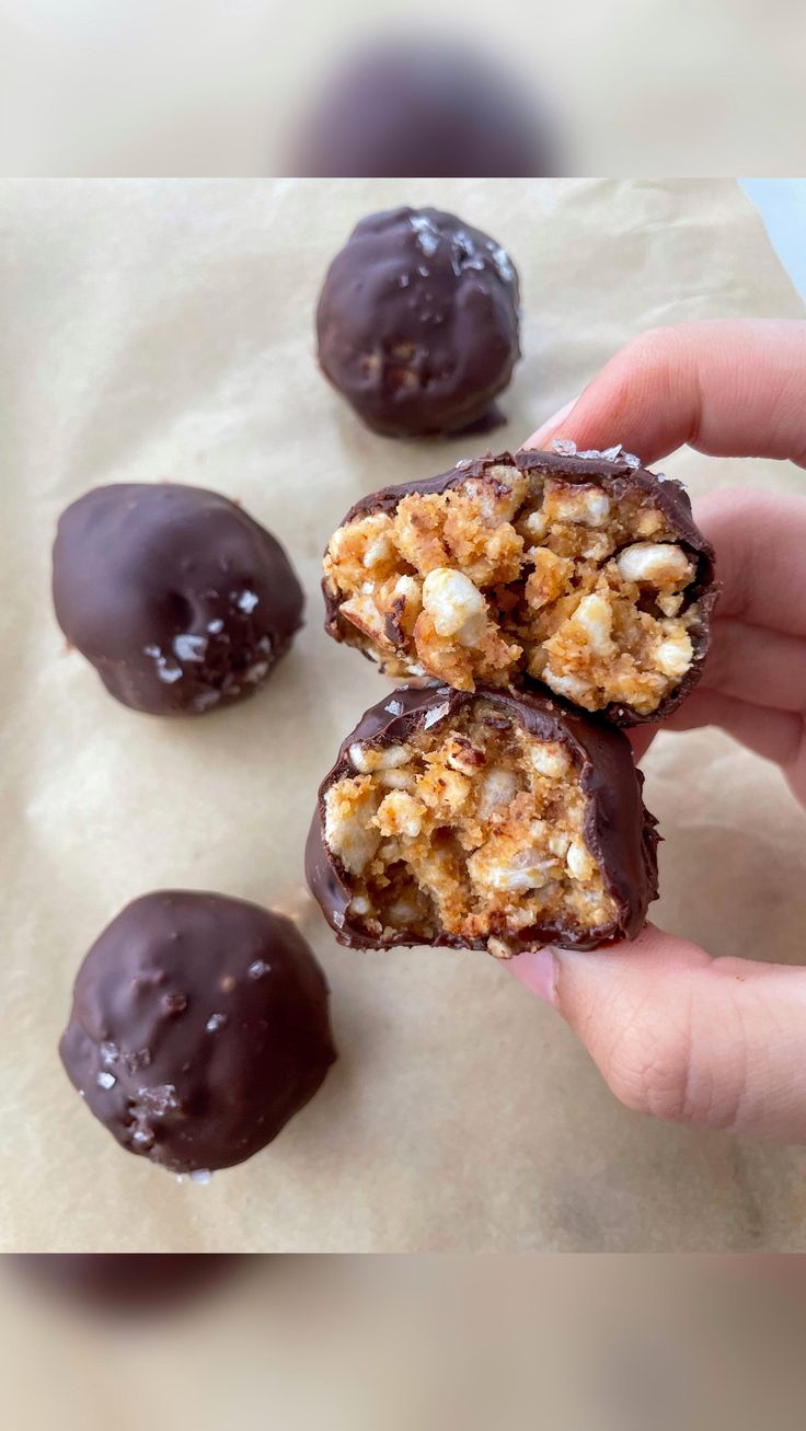 a person is holding some chocolate covered treats