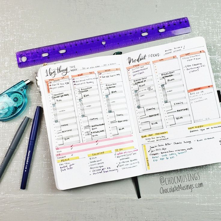 an open planner with pens, ruler and pencils next to it on a table