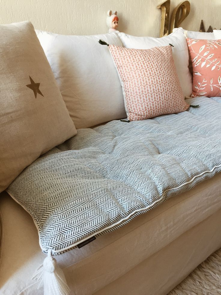 a couch with several pillows on top of it