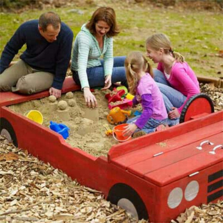 the family is playing in the sandbox