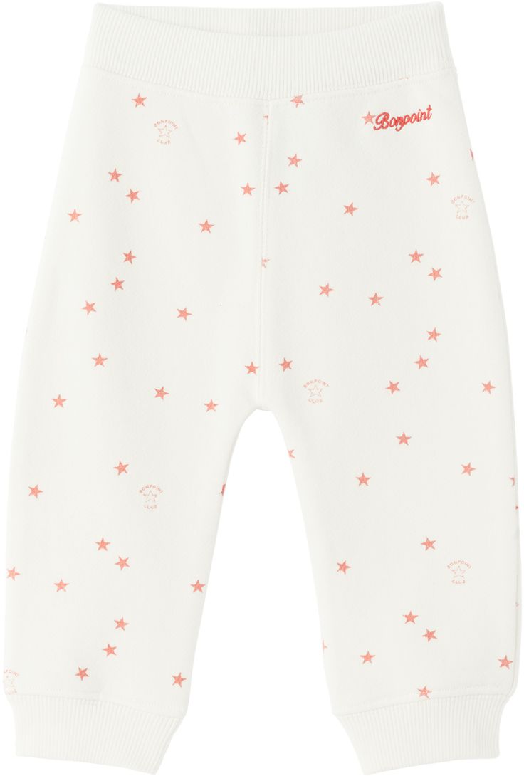 French terry sweatpants. Graphic pattern and logos printed throughout. · Rib knit elasticized waistband · Single-pocket styling · Logo embroidered at front · Rib knit cuffs · Machine-wash Supplier color: Ivoire Bonpoint Size: child's height 6M: 26 / 66 cm 12M: 28.75 / 73 cm 18M: 32 / 81 cm 2Y: 33.75 / 86 cm 3Y: 37.75 / 96 cm White Cotton Joggers With Ribbed Cuffs, White Letter Print Bottoms For Loungewear, White Cotton Pants With Ribbed Cuffs, White Bottoms With Ribbed Cuffs, White Letter Print Sweatpants For Loungewear, White Pants With Ribbed Cuffs For Loungewear, Sporty White Pants With Elastic Cuffs, White Cotton Sweatpants With Elastic Cuffs, White Cotton Sweatpants With Comfort Waistband