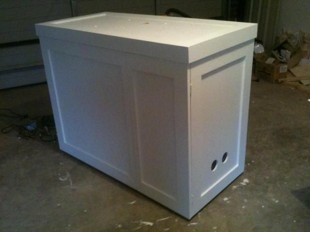 a white cabinet sitting on top of a floor