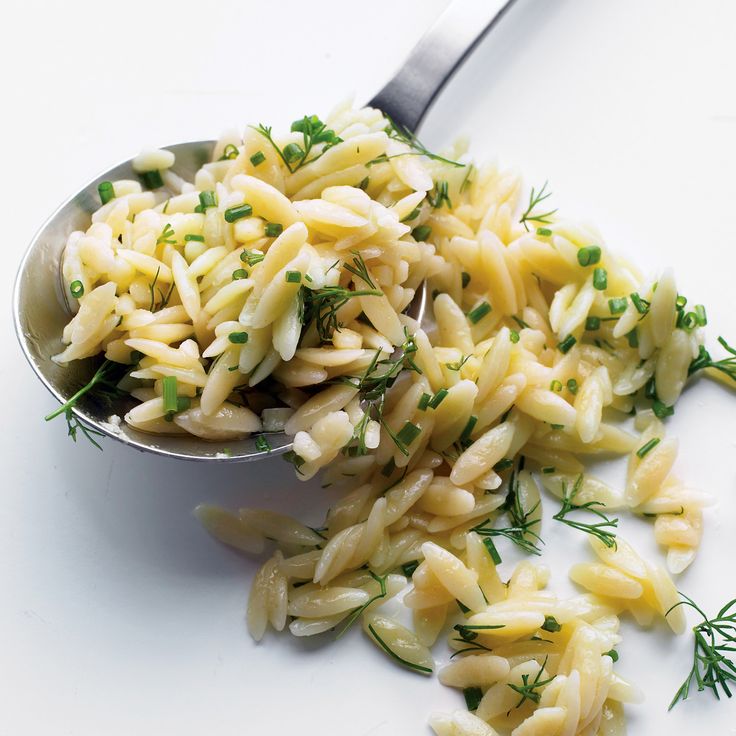 a spoon full of pasta with parsley on top