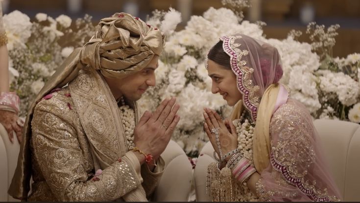 two women in wedding outfits sitting next to each other