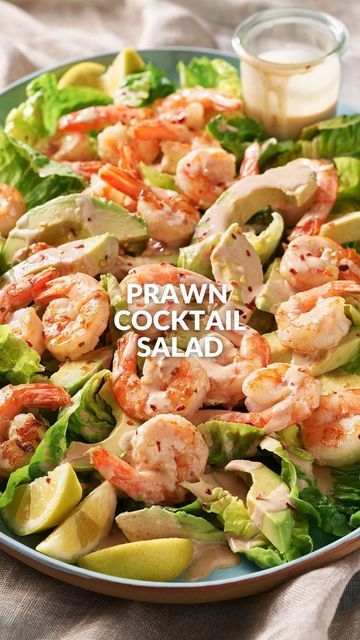 a plate with shrimp, lettuce and avocado on it