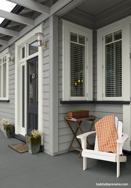 a white chair sitting on top of a wooden porch