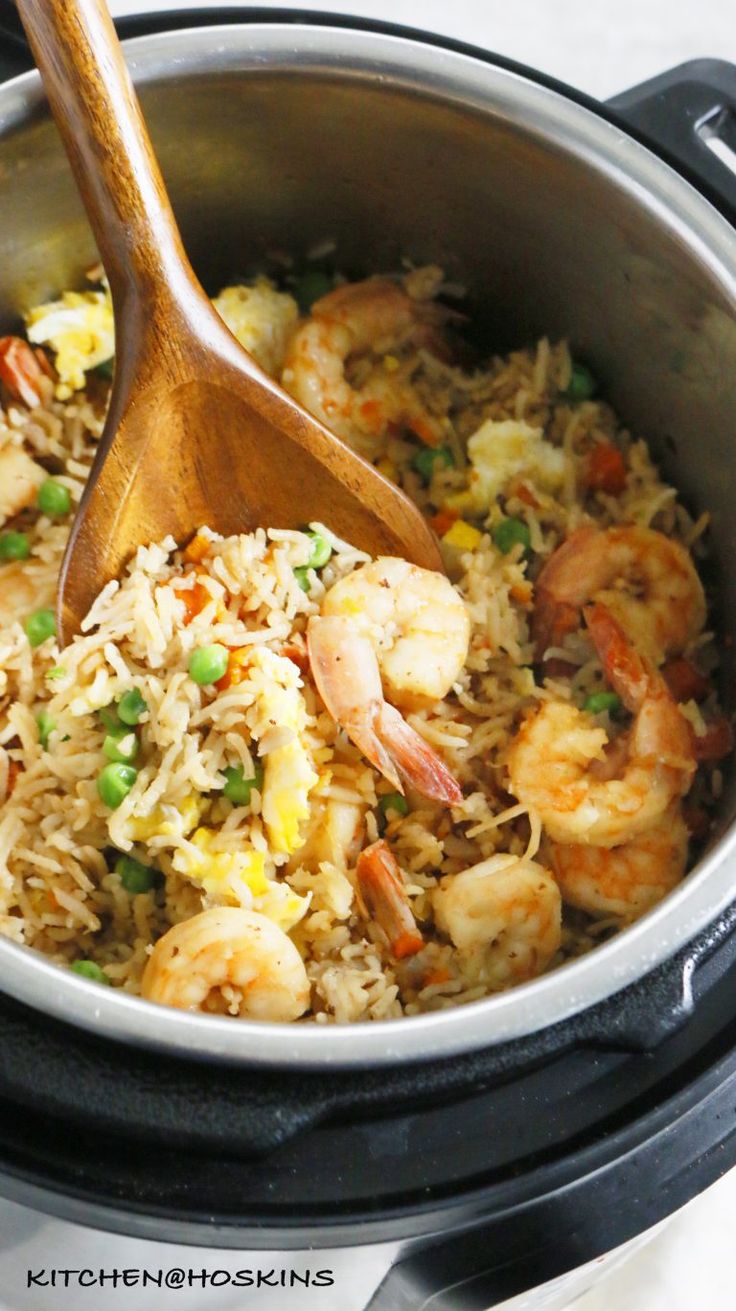 shrimp and rice in an instant pot with a wooden spoon