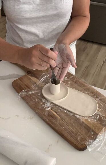 a woman is making some kind of dough on a cutting board with a rolling pin