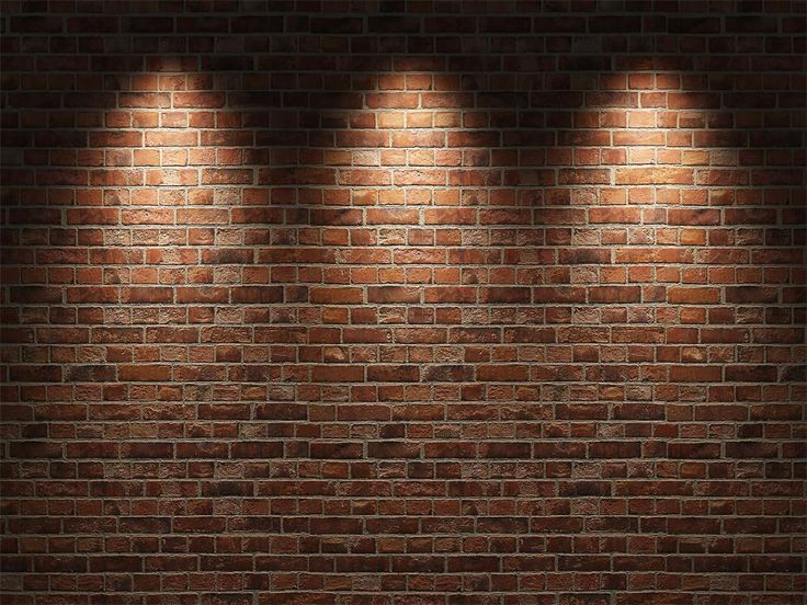 three spotlights are shining on a brick wall